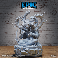 Unpainted grey resin Primeval Idol miniature on a 76.5mm scenic base — a large cross-legged eldritch figure with a tentacled face crowned by seven coiling serpent heads with barbed horns, taloned hands resting in its lap, snakes spiralling around the rocky base. Epic Miniatures sculpt #3629.