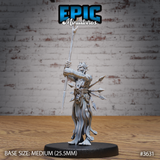 Front view of an unpainted grey resin 32mm miniature of a gaunt shirtless heretic with bone spikes on his skull, raising a long bone staff overhead with one arm while javelins, bones, and a skull trophy are strapped to his waist — mounted on a medium 25.5mm black base