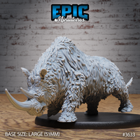Unpainted grey resin woolly rhinoceros miniature, front three-quarter view, showing dense layered fur texture, large curved horn, and muscular lowered head on a 51mm large oval black base