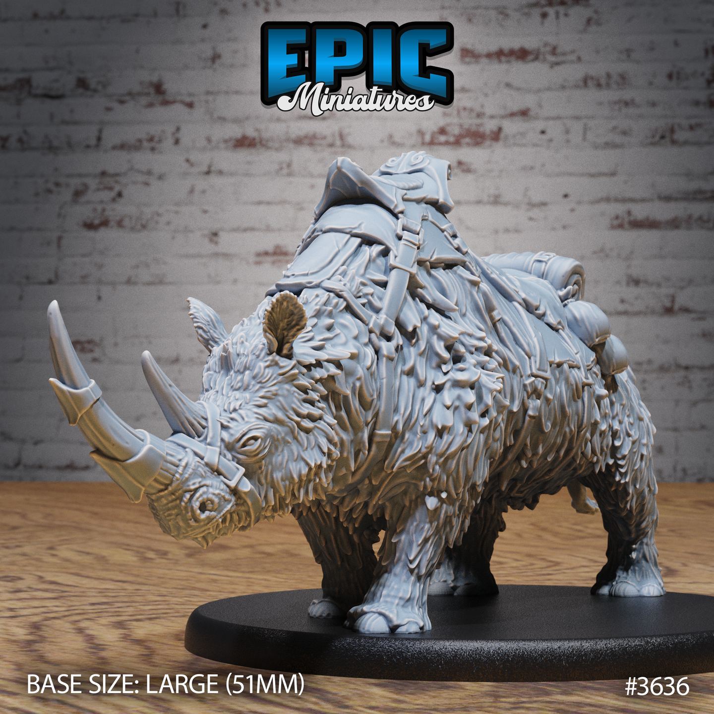 Front three-quarter view of an unpainted grey resin woolly rhino miniature on a 51mm oval base, showing shaggy fur texture, twin horns with metal cap on the primary horn, and detailed leather saddle with armour plates, bedroll, and pouches strapped across its back