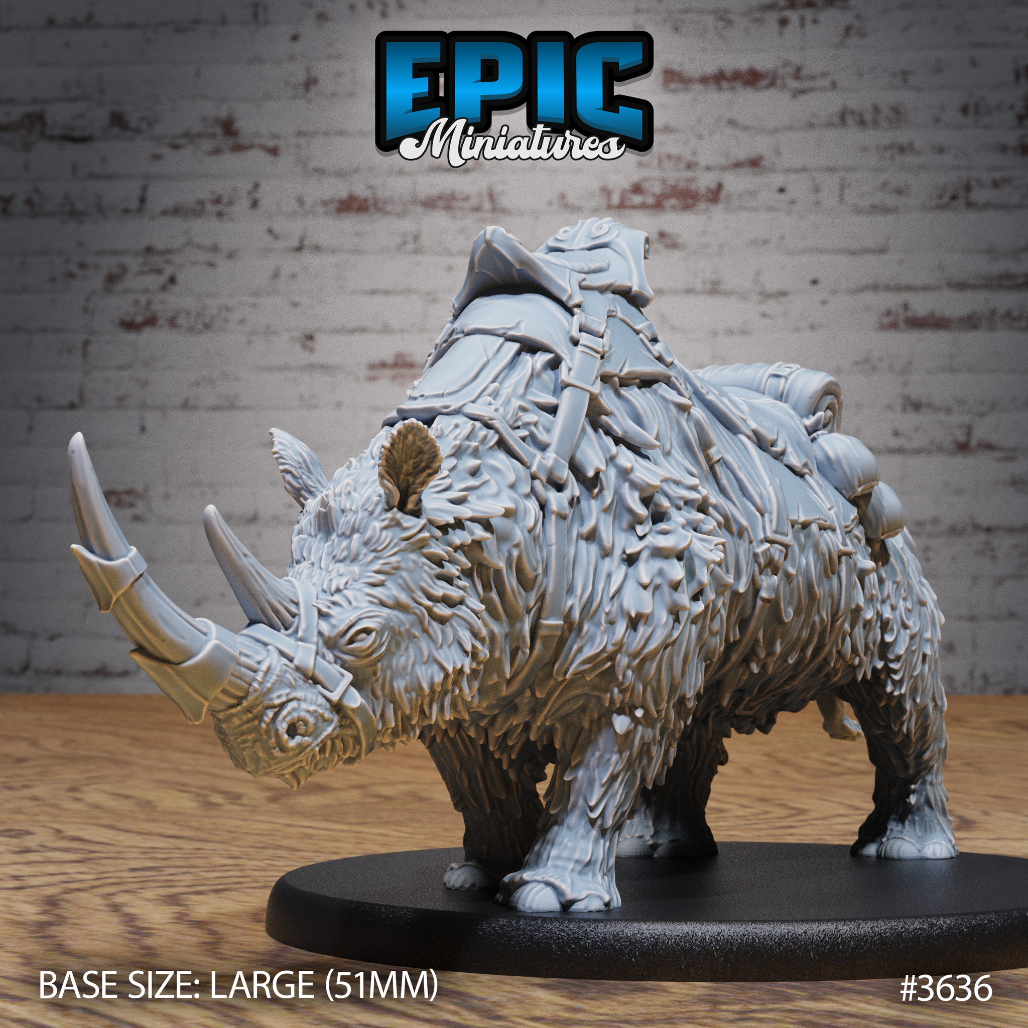 Front three-quarter view of an unpainted grey resin woolly rhino miniature on a 51mm oval base, showing shaggy fur texture, twin horns with metal cap on the primary horn, and detailed leather saddle with armour plates, bedroll, and pouches strapped across its back