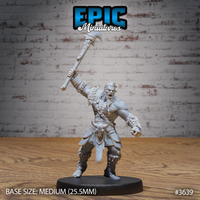 Unpainted grey resin miniature of a male tribal barbarian photographed from the front, axe raised overhead mid-swing, roaring expression, wearing knotwork shoulder armour, fur-trimmed boots and bracers, with a horned skull trophy at his belt, on a 25.5mm round black base