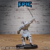 Unpainted grey resin miniature of a male tribal barbarian photographed from the rear, showing the engraved knotwork on his shoulder guard, axe held aloft, fur and hide trim on his lower garments and boots, on a 25.5mm round black base
