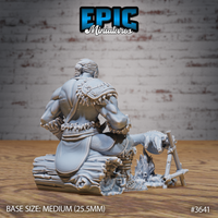 Rear view of the unpainted grey resin tribal barbarian miniature showing a thick braided hair bun, detailed beast-jaw pauldron with fur trim across the back, layered hide armour, and the campfire scatter piece with carcass frame and flame base — 32mm scale by Epic Miniatures