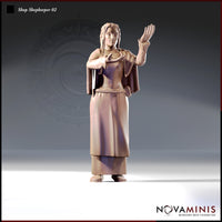 Digital render of Shopkeeper 02 miniature by Novaminis — a female figure with long braided hair in a layered flowing robe with rope belt, one hand raised in refusal and the other cupped forward, viewed from the front