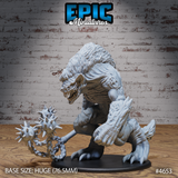 Front view of an unpainted grey resin Yeenoghu Demon Lord miniature on a 76.5mm base — a massive hunched gnoll-demon with open jaws, thick fur and scaled hide, wielding a spiked flail on a heavy chain in his left hand, right hand clawed and raised, clawed feet gripping the base