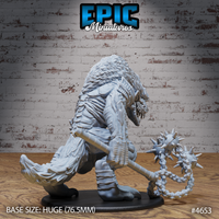 Rear three-quarter view of the unpainted grey resin Yeenoghu miniature showing heavily textured scaled back, feathered hindquarters, lashing tail, and the spiked flail extended outward on its chain — photographed against a white brick wall background with wooden floor
