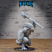 Unpainted grey resin miniature of Yeenoghu the Demon Lord, front view — hunched predatory pose with stone maul raised overhead, detailed scaled hide and exposed ribcage, on a huge 76.5mm round base. Epic Miniatures sculpt #4654.