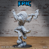 Rear view of the same unpainted grey resin Yeenoghu miniature showing the detailed textured mane, spinal ridges, clawed feet, and the reverse of the engraved axe blade, mounted on a huge 76.5mm black round base
