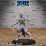Rear view of the same unpainted female jackalwere resin miniature, showing her braided locs, laced leather back panel, armoured skirt, and digitigrade feet, with both blades raised in a dual-wield fighting stance