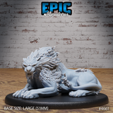 Front three-quarter view of an unpainted grey resin sabertooth beast miniature by Epic Miniatures, shown in a resting pose with forelimbs extended, head raised and teeth bared in a snarl, with a dramatic layered feathered mane and broad clawed paws, mounted on a large 51mm oval black base
