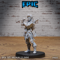 Front view of an unpainted grey resin orc female miniature on a 25.5mm black base — wild crested hair with bone rings, one fist raised in a taunting pose, axe slung across the back, layered tribal wraps on arms and legs, skull and bone charms at the belt, fur-trimmed boots