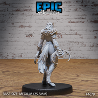 Rear view of the same unpainted grey resin armoured female werewolf miniature by Epic Miniatures — showing articulated back armour, feathered leg guards, a sweeping fur mane over the shoulders, and a curved tail with large hooked claws visible at the side. Medium 25.5mm base visible.