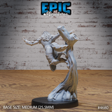 Rear view of unpainted grey resin armoured female werewolf miniature showing raised knee mid-jump pose, wild fur crown, trailing cloak-like base, and detailed scale armour plates — 32mm scale by Epic Miniatures