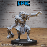 Front view of an unpainted grey resin gnoll warrior miniature at 32mm scale — armoured chest piece with engraved swirl details, snarling canine head with bared teeth, right hand trailing a spiked flail on a chain, left arm outstretched with clawed fingers extended, mounted on a 25.5mm medium round base