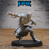 Front view of an unpainted grey resin miniature of a savage escapee — a wild-haired male human crouching low with both arms flung wide, fingers spread like claws, wearing tattered clothing with shackle cuffs on both wrists, mounted on a medium 25.5mm round base