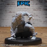 Front view of an unpainted grey resin 32mm miniature of a muscular male human in a crouching combat stance, wearing torn clothing with shackles on his bare feet, one hand on the ground and one raised, mounted on a medium 25.5mm round base — Epic Miniatures sculpt #4699