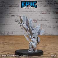 Rear three-quarter view of the unpainted grey resin Wasp Swarm miniature by Epic Miniatures — showing segmented wasp abdomens, veined wings, and the honeycomb hive base in detail. Medium 25.5mm base. Reference number 4704.