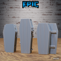 Three unpainted grey resin coffin terrain pieces from Epic Miniatures shown from the rear and side: left coffin with carry handles, centre coffin with heavy chains wrapped around the exterior and a small bolt fitting, right coffin with iron hinge and bar fittings on the side — photographed on a wooden surface against a brick background