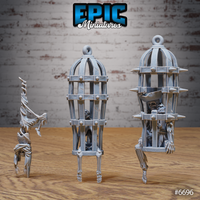 Three unpainted grey resin skeleton cage miniatures from Epic Miniatures — a ribbed birdcage on bone stilts with a huddled skeleton inside, a taller spike-collared cage containing an armoured skeleton, and a freestanding skeleton in a dramatic handstand pose, photographed on a wooden surface against a brick wall background