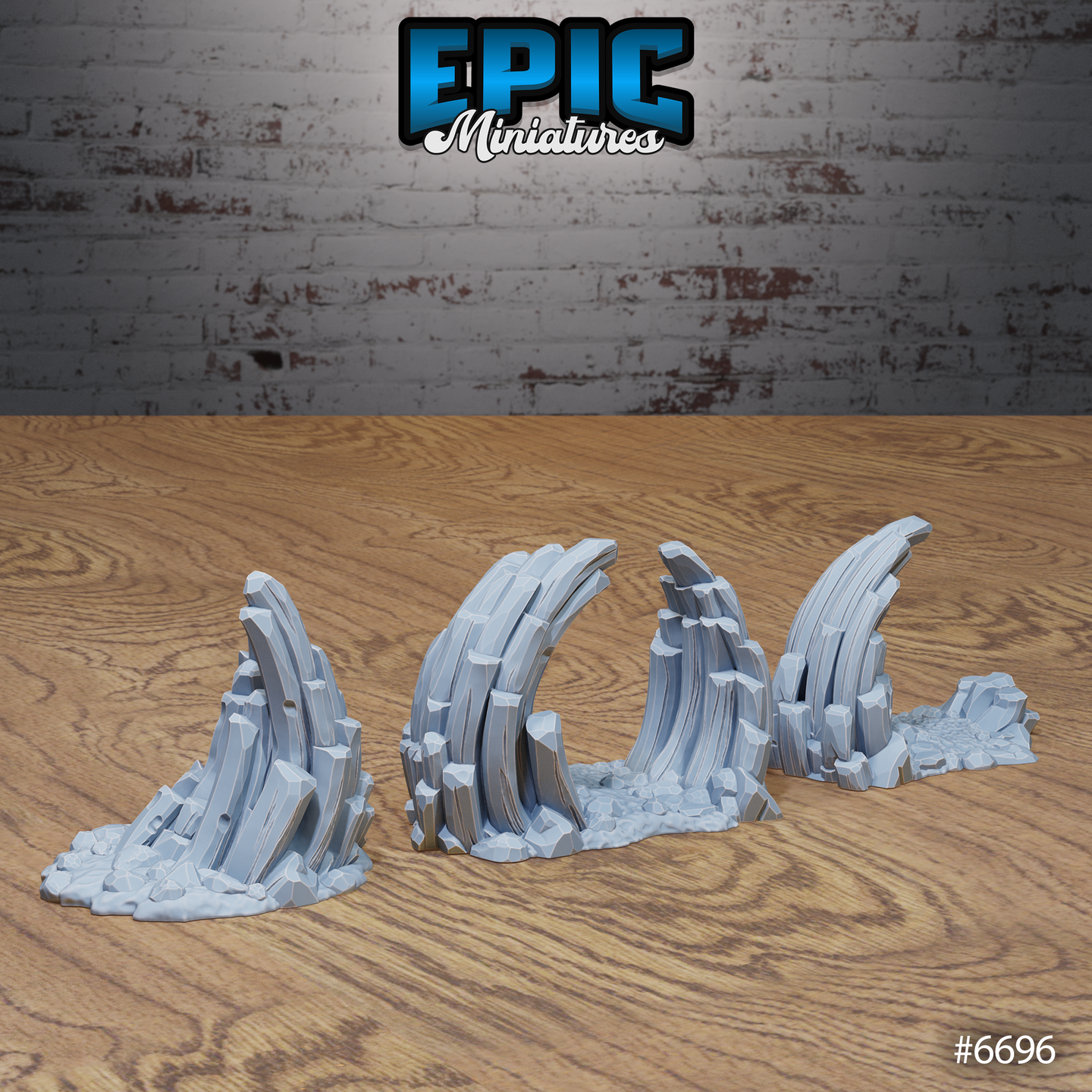 Rear three-quarter view of four unpainted grey resin stone rock formation terrain pieces showing varied heights and forms — a tall single spire, a broad arching slab pair, a mid-height curved formation, and a low broken outcropping — all displaying detailed layered rockwork and scattered rubble at their bases