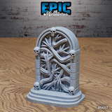 Unpainted grey resin dark gate terrain piece with skull-adorned stone arch, grasping tendrils coiling across a closed wooden door, six skulls set into the frame, and a raised stepped plinth base — sculpted by Epic Miniatures