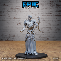 Front view of an unpainted grey resin Vecna miniature by Epic Miniatures — a gaunt lich in flowing robes with exposed ribcage, horned skull face, blade pauldrons, one arm raised with curled fingers and the other in a fist, mounted on a large 51mm black round base