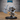 Unpainted grey resin miniature of an armoured skeleton warrior gripping a large spiked battle-axe in both hands, wearing a horned helmet with skull motifs, posed aggressively on a 25.5mm medium round base — Epic Miniatures Evil Skeleton by Mitz & Simz
