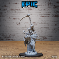 Front view of an unpainted grey resin Wraith Mother miniature by Epic Miniatures — a female undead figure rising from a skull-strewn base, holding a spine-forged scythe aloft in one hand and a skull against her torso with the other, her tattered robes billowing dramatically around her on a large 51mm base