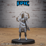 Front view of an unpainted grey resin 32mm miniature of a novice lich — a gaunt undead spellcaster in tattered robes, arms raised with magical energy tendrils coiling from both hands, adorned with layered necklaces and geometric arcane beltwork, mounted on a medium 25.5mm black base