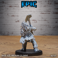 Rear view of the unpainted grey resin Turtlefolk Grave Robber miniature by Epic Miniatures, showcasing the heavily detailed back of the spiked and crystal-encrusted cape, flowing cloak, and bound leg wrappings, with the maul still raised in the attack pose