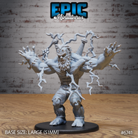 Front view of an unpainted grey resin Electric Frankenstein miniature on a 51mm black round base — a massive humanoid creature mid-roar with arms spread wide, jagged lightning bolts crackling from both clawed hands, wild hair, a snarling bestial face, and two mechanical coil devices visible on its back, photographed against a brick wall background