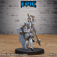 Rear view of the unpainted grey resin Amazoness Fighter miniature by Epic Miniatures — showing the back of her layered armour, cascading locs, decorative sash, and a long spear or polearm strapped across her back, on a medium 25.5mm round base