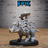 Front view of an unpainted grey resin Mushroom Boar miniature on a dark round base — a tusked boar covered in layered leaves, vines, and clusters of mushrooms rising to a tall flat-capped fungus crown, viewed from the front-left at table level
