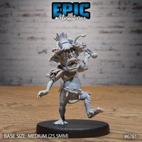 Unpainted grey resin 32mm miniature of a jungle goblin mid-attack — wide-mouthed battle cry, bone club raised, feather and horn ritual headdress, rope belt with fetishes, one clawed foot raised mid-stride, on a 25.5mm round black base