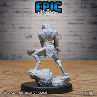 Rear view of the unpainted grey resin Frog Folk Hunter miniature showing muscular back detail, splayed webbed feet, studded belt, and the serrated club weapon, 32mm scale by Epic Miniatures