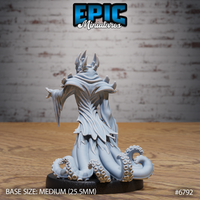Rear view of the same robed figure showing layered blade-edged vestments with deep carved folds, horned crown, and thick tentacles coiling around the base. Sculpt by Epic Miniatures.
