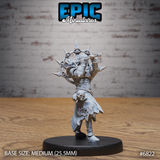 Armoured knight in mid-swing pose raising a mace, wearing a torn skull-emblazoned tabard, with a large spiked wheel bearing multiple open eyes replacing the helmet entirely. Sculpt by Epic Miniatures.