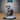 Shoggoth Monk by Epic Miniatures — hunched aberrant figure with cloak swept back, reaching forward with multi-jointed clawed arms, cyclopean eye visible in ridged face, crouching on rubble base with fallen sword. Large 51mm base.