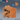 Digital render of the Mimic Crate miniature by Epic Miniatures — an unpainted orange resin sculpt depicting a wooden storage crate split open to reveal a wide maw filled with jagged teeth, a curling tongue, and two small eyes peering from the brow. A scale reference showing a d20 and a plain crate is visible in the upper right corner. Labelled as medium size.