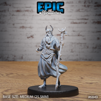 Bearded antlered druid holding a gnarled branching staff in one hand, robes billowing with flowing folds, one hand raised with fingers curled, standing on a round decorative base. Sculpt by Epic Miniatures.