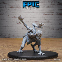 Frenzied female figure crouched low with one arm raised high and clawed hands splayed, reptilian scaled legs with taloned feet, open-mouthed expression, wearing a cloth wrap and narrow headband. Sculpt by Epic Miniatures.