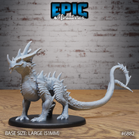 Crystal Guard Drake by Epic Miniatures — rear view showing the long whip-like barbed tail sweeping outward, with the raised crown of asymmetrical horns and heavy spinal ridges clearly visible across the back.