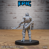 Scale mail-clad guard seen from behind, forked crossbow held across the body, buckled leg armour and greaves visible, lantern hanging at the hip. Sculpt by Epic Miniatures.