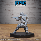 Armoured guard in a low kneeling stance seen from behind, crossbow extended ahead, scale mail covering the back and shoulders, a bolt quiver at the hip, greaves and articulated armour plates visible. Sculpt by Epic Miniatures.