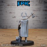 Crusader knight seen from behind, broad cloak falling to mid-calf, halberd raised with axe-head visible above the shoulder, horned halo cresting the visored helm, shield strapped at the back, standing on a rough rocky base. Sculpt by Epic Miniatures.