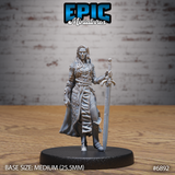 Female knight standing upright, resting a long ornate sword point-down at her side, wearing layered plate and scale armour with a full-length cloak and loose long hair. Sculpt by Epic Miniatures.
