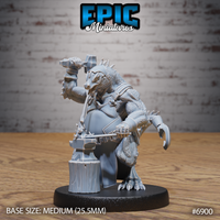 Snarling kobold blacksmith crouched over a wooden stump anvil, hammer raised overhead in one clawed hand, wearing a leather apron and tool belt, with a satchel on his back and dorsal spines running up his neck. Sculpt by Epic Miniatures.