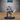 Fully armoured knight in a wide braced stance, gripping a long-hafted scythe with both gauntleted hands, blade sweeping outward. Plate armour with chevron detailing, closed-visor helm, billowing cape. Sculpt by Epic Miniatures.