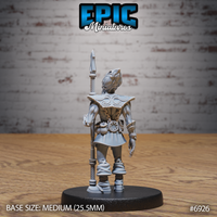 Illithid guard seen from behind, showing engraved swirling patterns across wide armoured pauldrons, a belt with wheel medallion, and wrapped lower legs. Sculpt by Epic Miniatures.